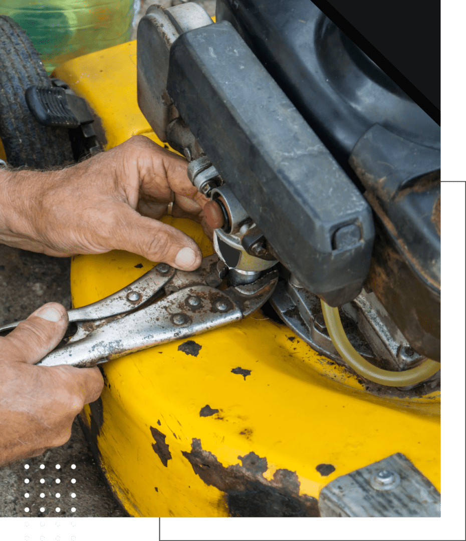 local-expert-11 Hands repairing a yellow lawnmower engine.
